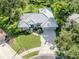 Aerial view showcasing the home's beautiful landscaping, concrete driveway, and elegant roofline at 337 Meadow Beauty Ct, Venice, FL 34293