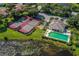 Aerial view showcasing community tennis courts and a pool, enhancing the appeal of an active lifestyle at 337 Meadow Beauty Ct, Venice, FL 34293