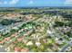 Aerial view of the community with various houses, green spaces, and roads, showing its layout at 337 Meadow Beauty Ct, Venice, FL 34293