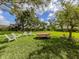 Relax and unwind in this beautiful backyard setting with a picnic table and Adirondack chairs at 337 Meadow Beauty Ct, Venice, FL 34293