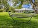 Expansive backyard featuring lush lawn, mature trees, and a relaxing hammock at 337 Meadow Beauty Ct, Venice, FL 34293