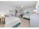 Cozy bedroom is well-lit with a ceiling fan and natural light with two comfortable twin beds at 337 Meadow Beauty Ct, Venice, FL 34293