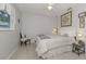 Cozy bedroom featuring a queen-sized bed, carpet, and bright natural lighting at 337 Meadow Beauty Ct, Venice, FL 34293
