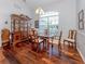 Formal dining room with a china cabinet, hardwood floors, and lots of sunlight at 337 Meadow Beauty Ct, Venice, FL 34293