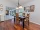 Bright dining area with hardwood floors, stylish lighting, and sliding glass doors to the outdoor patio at 337 Meadow Beauty Ct, Venice, FL 34293