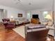 Comfortable living room featuring hardwood floors and lots of seating at 337 Meadow Beauty Ct, Venice, FL 34293