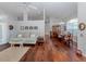 Open-concept living room with hardwood floors, sofa, and dining area at 337 Meadow Beauty Ct, Venice, FL 34293