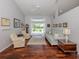 Cozy living room with a ceiling fan, hardwood floors, and views of the backyard at 337 Meadow Beauty Ct, Venice, FL 34293