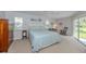 Serene bedroom features a plush bed, rocking chair, and sliding glass doors to the outside at 337 Meadow Beauty Ct, Venice, FL 34293