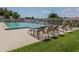 Community pool with lounge chairs is ideal for relaxing and enjoying the sun at 337 Meadow Beauty Ct, Venice, FL 34293