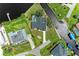 Aerial view of a waterfront property with a pool, boat dock, and canal access on a well-maintained lawn at 3376 Peace River Dr, Punta Gorda, FL 33983