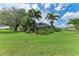 Large backyard showcasing outdoor living with mature landscaping at 3376 Peace River Dr, Punta Gorda, FL 33983