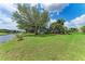 Expansive backyard with lush lawn and waterfront access at 3376 Peace River Dr, Punta Gorda, FL 33983