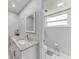Bathroom featuring a granite countertop, white cabinets and fixtures at 3376 Peace River Dr, Punta Gorda, FL 33983