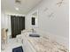 Bathroom with granite countertops, white cabinets, and decorative starfish at 3376 Peace River Dr, Punta Gorda, FL 33983
