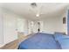 Bedroom with ensuite bathroom, closet, wood-look flooring, and ceiling fan at 3376 Peace River Dr, Punta Gorda, FL 33983