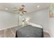 Comfortable bedroom with ceiling fan, neutral walls and light, wood-look floors at 3376 Peace River Dr, Punta Gorda, FL 33983