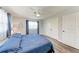 Bedroom with wood-look flooring, nautical decor, and a ceiling fan at 3376 Peace River Dr, Punta Gorda, FL 33983