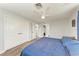 Bedroom featuring wood-look flooring, closet, and views to ensuite bathroom and closet at 3376 Peace River Dr, Punta Gorda, FL 33983