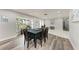 Dining room with wood floors, ample seating, and views of the front yard at 3376 Peace River Dr, Punta Gorda, FL 33983
