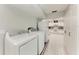 Laundry room with washer, dryer, and kitchen in the background at 3376 Peace River Dr, Punta Gorda, FL 33983
