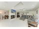Living room with fireplace, TV and backyard views, connected to the dining area at 3376 Peace River Dr, Punta Gorda, FL 33983