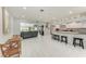 Open-concept living room with tile floors, bar seating, and water views at 3376 Peace River Dr, Punta Gorda, FL 33983