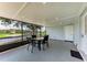 Screened patio with canal view and outdoor table setting at 3376 Peace River Dr, Punta Gorda, FL 33983