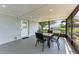 Canal-view screened patio with table and chairs at 3376 Peace River Dr, Punta Gorda, FL 33983