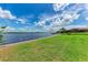 Lush green lawn leading to serene waterfront and private dock at 3376 Peace River Dr, Punta Gorda, FL 33983