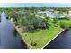 Waterfront home with spacious lawn, mature trees, and canal access offering a serene and private setting at 3376 Peace River Dr, Punta Gorda, FL 33983
