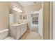 Bright bathroom features a large mirror and tile flooring at 3633 Parkridge Cir # 10-201, Sarasota, FL 34243