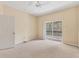 Neutral bedroom with a ceiling fan and sliding glass doors to a balcony at 3633 Parkridge Cir # 10-201, Sarasota, FL 34243