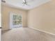 Bright bedroom features a ceiling fan and a sliding glass door to a balcony at 3633 Parkridge Cir # 10-201, Sarasota, FL 34243