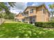 Exterior view of townhomes featuring well-manicured lawn and screened in patio and balcony at 3633 Parkridge Cir # 10-201, Sarasota, FL 34243