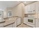 Well-lit kitchen with white appliances and plenty of counter space at 3633 Parkridge Cir # 10-201, Sarasota, FL 34243