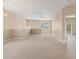 Open living space featuring neutral carpet, a ceiling fan, and a balcony door at 3633 Parkridge Cir # 10-201, Sarasota, FL 34243