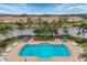 Aerial view of community pool with lake views and palm trees at 3633 Parkridge Cir # 10-201, Sarasota, FL 34243