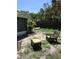 Backyard sitting area with green chairs and a yellow kayak near the screen porch at 3661 Sterling Rd, Venice, FL 34293