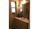 Cozy bathroom with a neutral palette, featuring a classic vanity and well-lit mirror at 3661 Sterling Rd, Venice, FL 34293