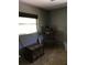 Bedroom with a trunk and a window, painted in neutral wall colors and carpet flooring at 3661 Sterling Rd, Venice, FL 34293
