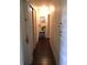 Hallway with wood floors and a plant near a little stool with overhead lighting at 3661 Sterling Rd, Venice, FL 34293