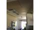 Kitchen under construction with white cabinets, stainless steel microwave and unfinished ceiling at 3661 Sterling Rd, Venice, FL 34293