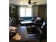 Cozy living room with comfortable seating, a ceiling fan and bright window for natural light at 3661 Sterling Rd, Venice, FL 34293