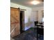 This office has a wooden sliding door and a Persian style area rug at 3661 Sterling Rd, Venice, FL 34293