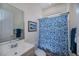 Modest bathroom with blue patterned shower curtain, and modern sink at 4308 Via Del Santi, Venice, FL 34293