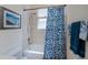 Standard bathroom with blue patterned shower curtain and natural light at 4308 Via Del Santi, Venice, FL 34293