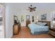 Bright bedroom with tray ceiling, neutral colors, tile flooring, and multiple windows at 4308 Via Del Santi, Venice, FL 34293