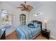 Bright bedroom with large windows, wicker furniture, tile floor and ceiling fan at 4308 Via Del Santi, Venice, FL 34293