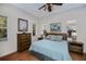 Comfortable bedroom with neutral colors, tile flooring, and natural light from the windows at 4308 Via Del Santi, Venice, FL 34293